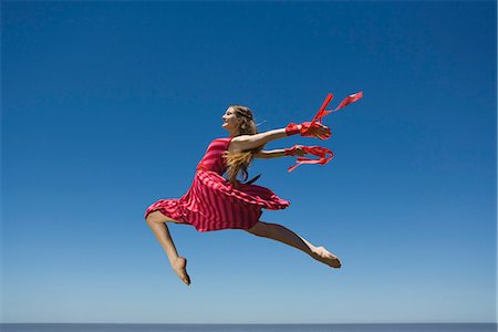 Young woman leaping, midair Stock Photo - Premium Royalty-Free, Code: 695-05770856