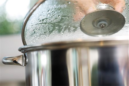 steam cooking - Person removing lid from steaming pot Stock Photo - Premium Royalty-Free, Code: 695-05770925