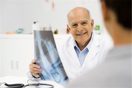 radiology patient - Doctor reviewing patient's x-ray Stock Photo - Premium Royalty-Free, Code: 695-05771239
