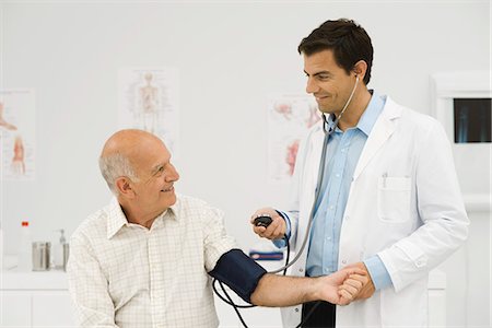pressure - Doctor checking patient's blood pressure Stock Photo - Premium Royalty-Free, Code: 695-05771260