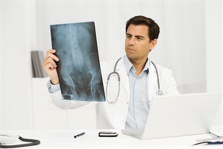 Doctor studying x-ray Stock Photo - Premium Royalty-Free, Code: 695-05771282