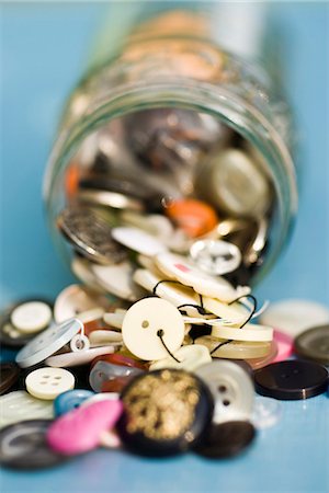 Buttons spilling out of jar Stock Photo - Premium Royalty-Free, Code: 695-05771448