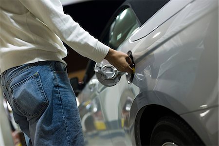 refuel - Driver opening gas tank to refuel at gas station Stock Photo - Premium Royalty-Free, Code: 695-05771634