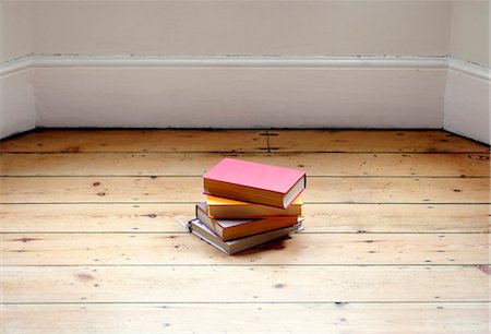 Books stacked on hardwood floor Stock Photo - Premium Royalty-Free, Code: 695-05771666