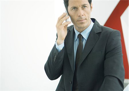 simsearch:6109-06685044,k - Businessman using cell phone Stock Photo - Premium Royalty-Free, Code: 695-05771954