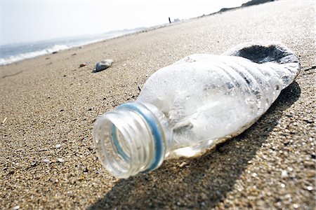 dirty environment - Plastic bottle on beach Stock Photo - Premium Royalty-Free, Code: 695-05772175