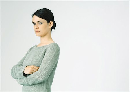 simsearch:400-04402256,k - Young woman standing with arms crossed, looking at camera Stock Photo - Premium Royalty-Free, Code: 695-05772328