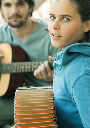 picture of the blue playing a instruments - Young woman playing accordian and young man playing guitar Stock Photo - Premium Royalty-Free, Code: 695-05772637