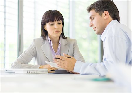 Man and woman having discussion in office Stock Photo - Premium Royalty-Free, Code: 695-05772799