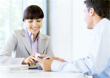 Man and woman having discussion in office Stock Photo - Premium Royalty-Free, Code: 695-05772801