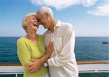 Mature couple embracing, laughing on boat deck Stock Photo - Premium Royalty-Free, Code: 695-05773424