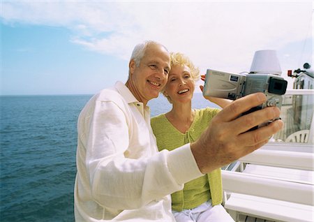 Mature couple making video of themselves on boat Stock Photo - Premium Royalty-Free, Code: 695-05773434