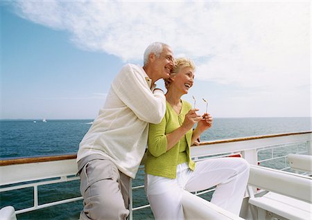 Mature couple leaning against railing, smiling Stock Photo - Premium Royalty-Free, Code: 695-05773438