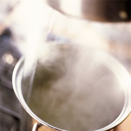 Close-up of steaming pot on stove Stock Photo - Premium Royalty-Free, Code: 695-05773472