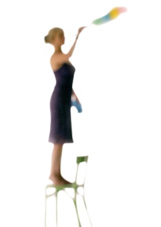 Silhouette of woman standing on chair and dusting, on white background, defocused Stock Photo - Premium Royalty-Free, Code: 695-05773505