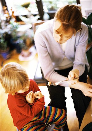 Woman feeding child Stock Photo - Premium Royalty-Free, Code: 695-05773853