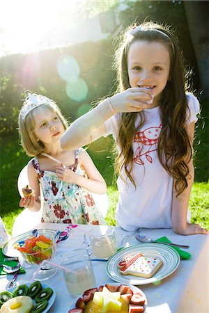 Girls eating sweets at birthday party Stock Photo - Premium Royalty-Free, Code: 695-05780002