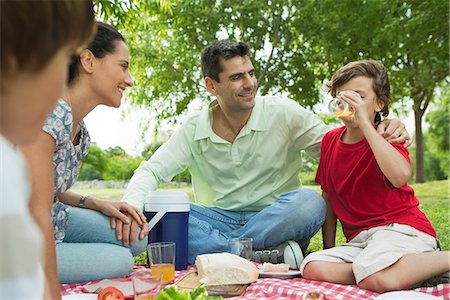 simsearch:632-05816381,k - Family enjoying picnic outdoors Stock Photo - Premium Royalty-Free, Code: 695-05780147