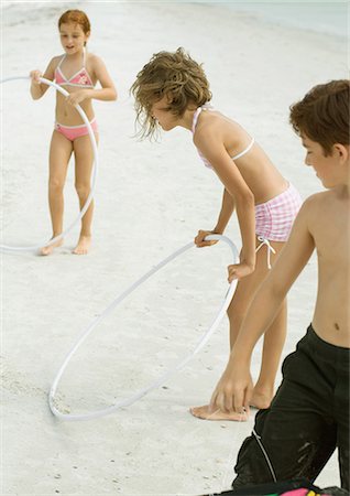 Kids playing with plastic hoops on beach Stock Photo - Premium Royalty-Free, Code: 695-03374036