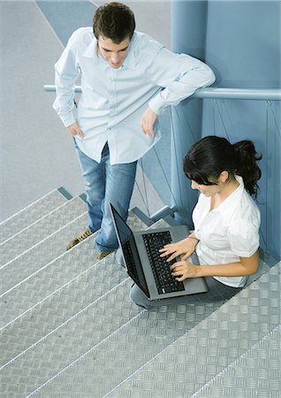 simsearch:695-05771662,k - Two colleagues talking, one sitting on stairs with laptop Stock Photo - Premium Royalty-Free, Code: 695-03374286
