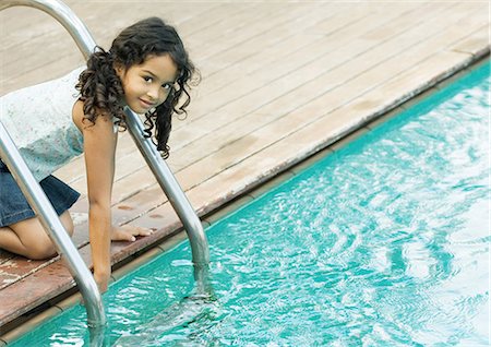 simsearch:695-03374346,k - Girl crouching by edge of pool, touching surface of water Stock Photo - Premium Royalty-Free, Code: 695-03374344
