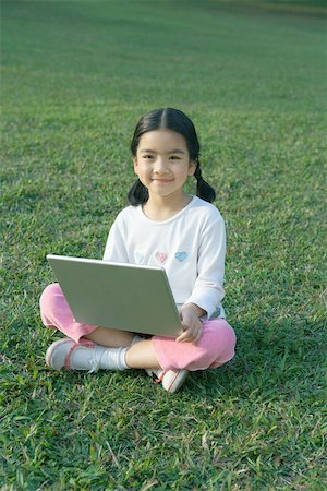 simsearch:614-06442812,k - Girl sitting in grass using laptop Stock Photo - Premium Royalty-Free, Code: 695-03374965