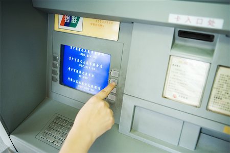 Person using ATM machine, cropped view Stock Photo - Premium Royalty-Free, Code: 695-03374971