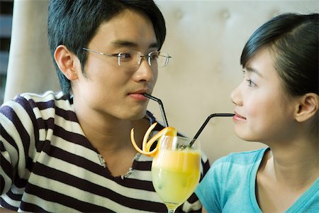 simsearch:400-04398921,k - Young couple sharing cocktail with two straws Stock Photo - Premium Royalty-Free, Code: 695-03375080