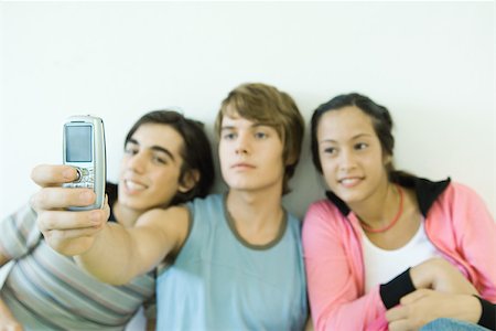 simsearch:695-03382482,k - Three teen friends taking self portrait with cell phone Stock Photo - Premium Royalty-Free, Code: 695-03375651