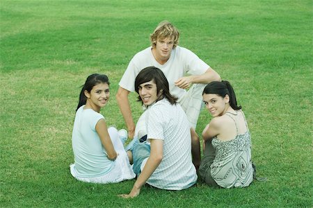simsearch:633-01715612,k - Four young friends sitting on grass, looking at camera Stock Photo - Premium Royalty-Free, Code: 695-03375720