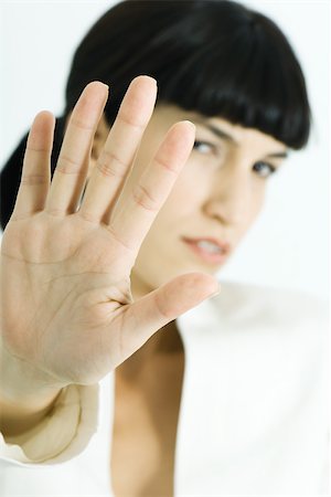 simsearch:632-05604001,k - Woman holding up palm to camera, portrait Stock Photo - Premium Royalty-Free, Code: 695-03375760