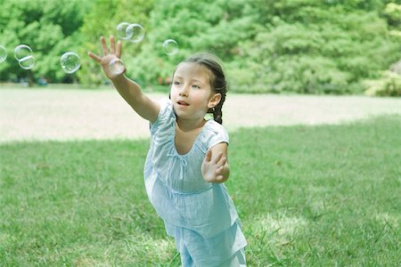 simsearch:614-07768068,k - Girl reaching for bubbles Stock Photo - Premium Royalty-Free, Code: 695-03375838