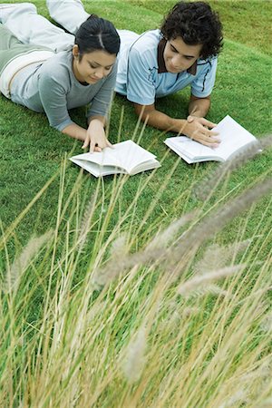 simsearch:633-01715612,k - Young couple lying on grass reading books Stock Photo - Premium Royalty-Free, Code: 695-03376074