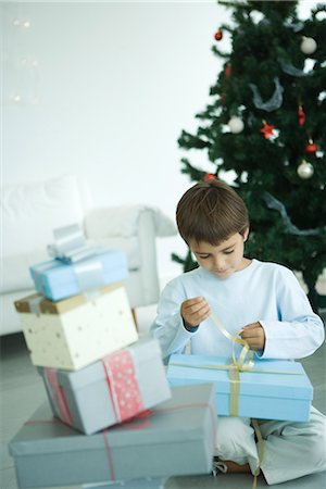 Boy opening Christmas presents Stock Photo - Premium Royalty-Free, Code: 695-03376089