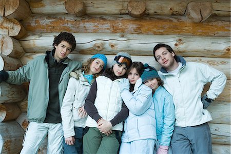 simsearch:695-03382482,k - Group in winter clothes standing together, leaning against log wall, three quarter length, portrait Stock Photo - Premium Royalty-Free, Code: 695-03376147