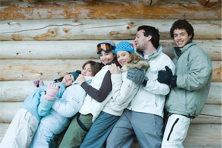 simsearch:695-03382482,k - Group in winter clothes falling back onto each other, three quarter length, in front of log wall, portrait Stock Photo - Premium Royalty-Free, Code: 695-03376148