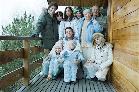 simsearch:696-03401677,k - Mixed age group standing on deck in winter clothes, group portrait, full length Stock Photo - Premium Royalty-Free, Code: 695-03376153
