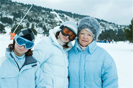 simsearch:696-03401677,k - Senior woman with teen and preteen granddaughters, wearing coats and hats, standing in snowy landscape Stock Photo - Premium Royalty-Free, Code: 695-03376184