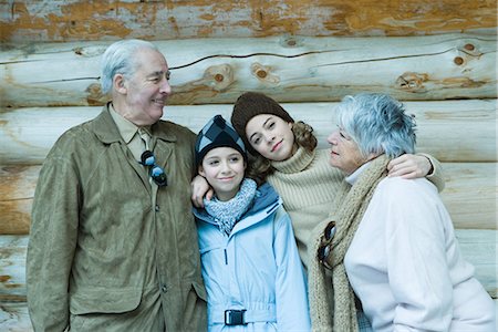 simsearch:696-03401677,k - Teen and preteen girls with grandparents, standing in front of log cabin with arms around each other, portrait Stock Photo - Premium Royalty-Free, Code: 695-03376181