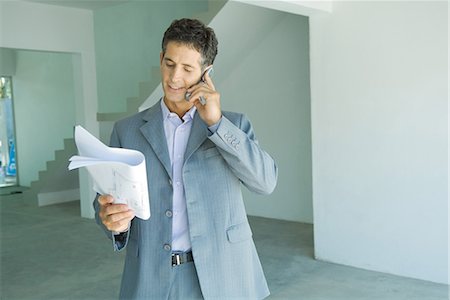 simsearch:695-03376228,k - Well-dressed man looking at blueprints, using phone Stock Photo - Premium Royalty-Free, Code: 695-03376194