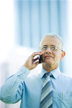 simsearch:695-03376228,k - Mature businessman using cell phone, smiling, front view Stock Photo - Premium Royalty-Free, Code: 695-03376254