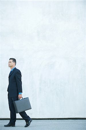 soul patch - Businessman walking, carrying briefcase, full length Stock Photo - Premium Royalty-Free, Code: 695-03376285