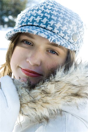 Teenage girl wearing parka and cap, close-up portrait Stock Photo - Premium Royalty-Free, Code: 695-03376363