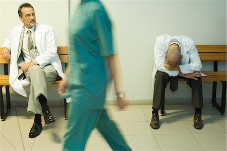 simsearch:632-01613036,k - Doctors sitting in hospital corridor, one with head down Stock Photo - Premium Royalty-Free, Code: 695-03376434