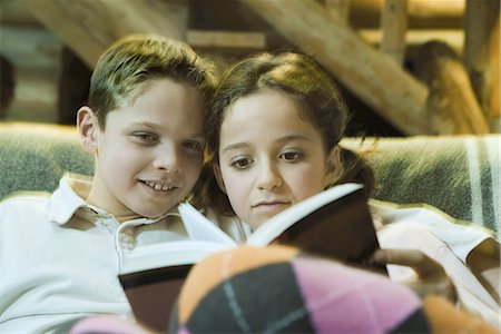 Preteen boy and girl reading book together Stock Photo - Premium Royalty-Free, Code: 695-03376572