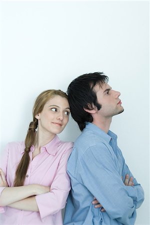 simsearch:632-01148228,k - Young couple, man turning back to young woman, arms crossed, waist up, portrait Stock Photo - Premium Royalty-Free, Code: 695-03376842