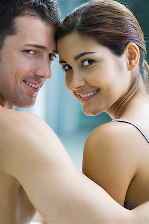 simsearch:695-05767104,k - Couple with heads together, looking over bare shoulders at camera Stock Photo - Premium Royalty-Free, Code: 695-03377015