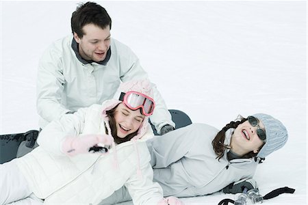 Young friends playing around in snow, laughing Stock Photo - Premium Royalty-Free, Code: 695-03377053