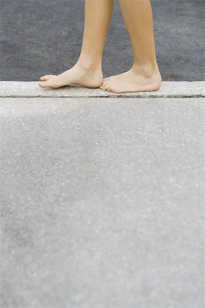 simsearch:695-03378125,k - Child walking along crack in sidewalk, cropped view of feet Stock Photo - Premium Royalty-Free, Code: 695-03377196