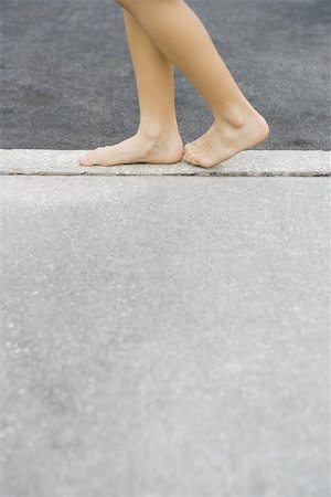 simsearch:695-03378125,k - Child walking along crack in sidewalk, cropped view of feet Stock Photo - Premium Royalty-Free, Code: 695-03377197